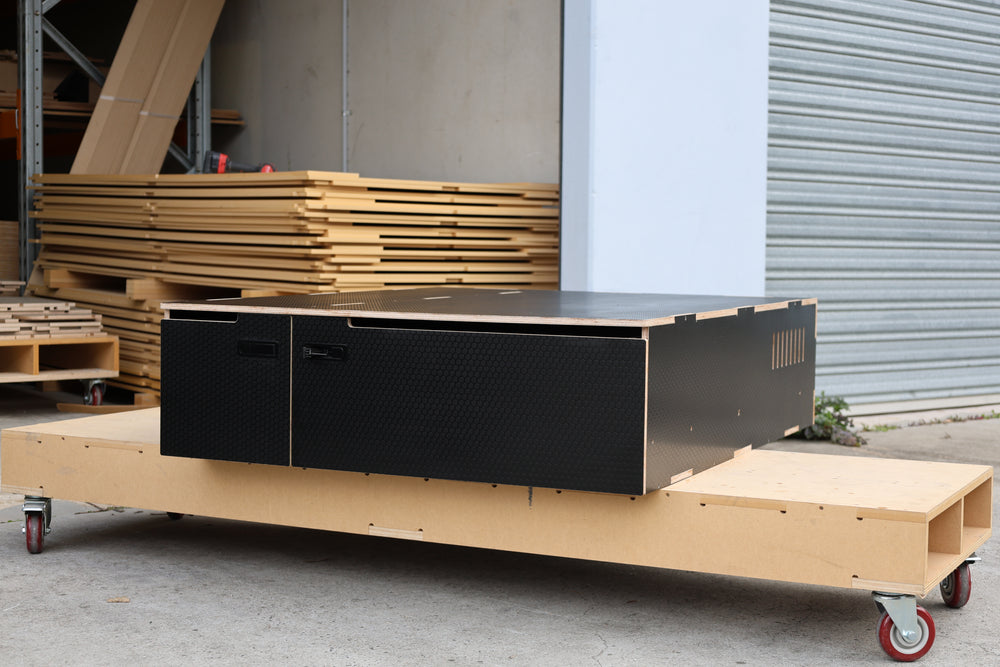 Black drawer module on a trolley outside the workshop