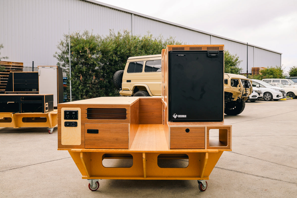 Ply Troopy cabinetry with an upright fridge on a workshop stand, ready to fit
