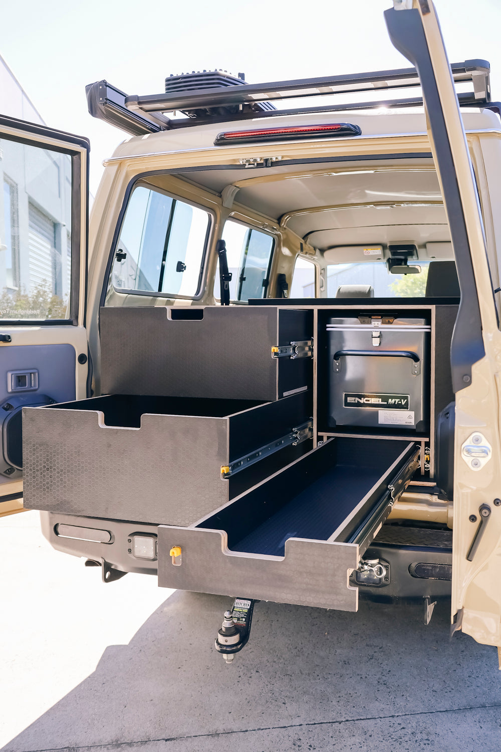 Troopcarrier rear with the drawers pulled out and an Engel fridge in its bay